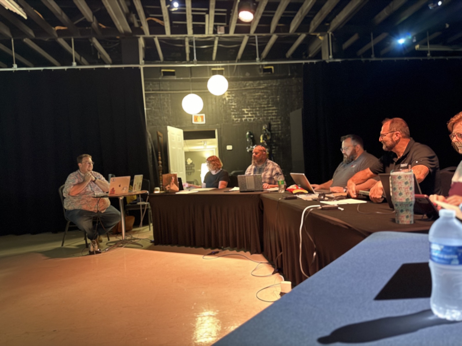 Brad Bear talks through a task with attendees across the studio tables during the hands-on block.